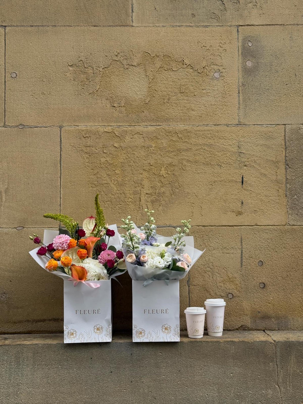 Two Fleurè bouquet boxes with coffee