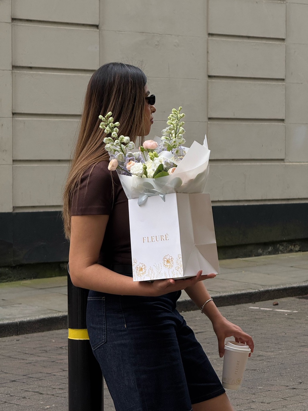 Customer carrying a Fleurè bouquet bag and signature drink